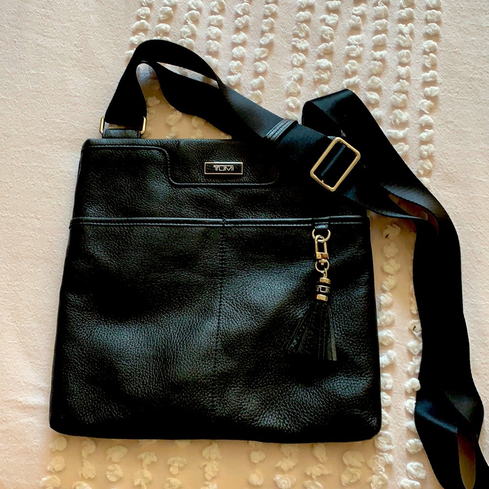 TUMI , Black Leather Crossbody , 2 outside packets, Nylon Strap, Like New.